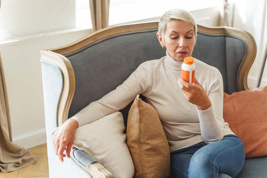 Woman holding a bottle of multivitamins