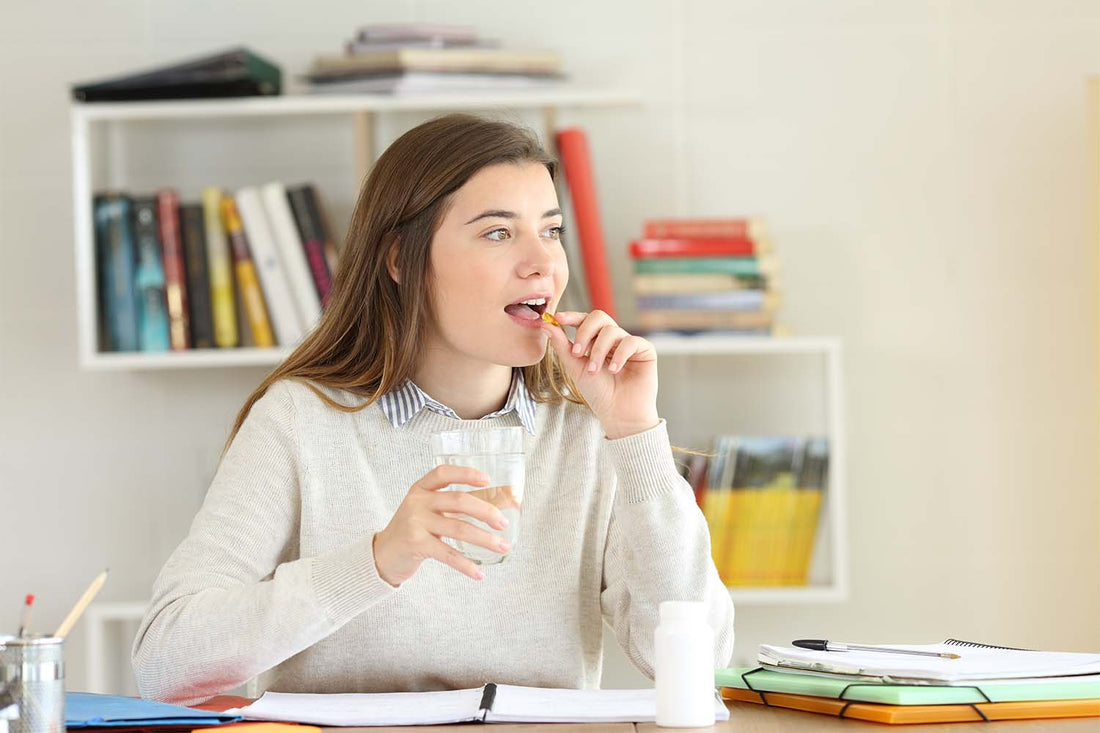 Smiling woman taking an immune system supplement