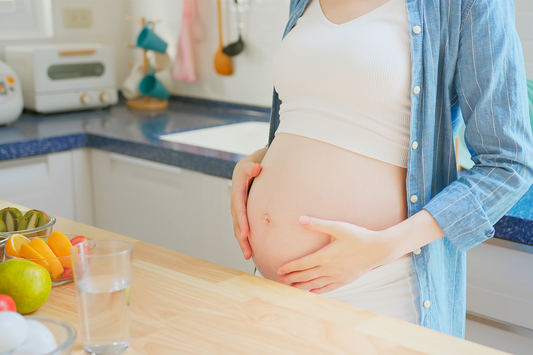 Pregnant woman standing in the kitchen