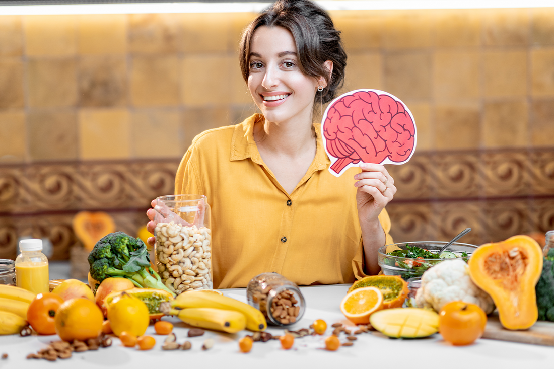 Smiling woman holding a cutout of the human brain