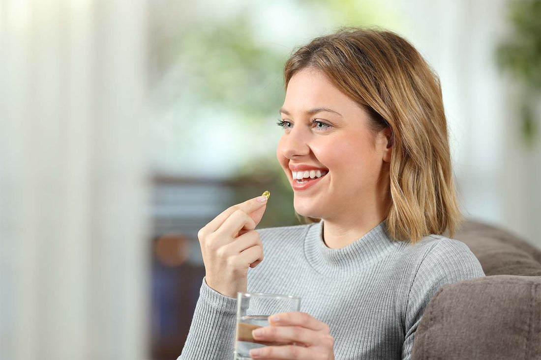 Smiling woman taking vitamins